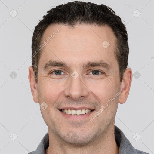 Joyful white adult male with short  brown hair and brown eyes