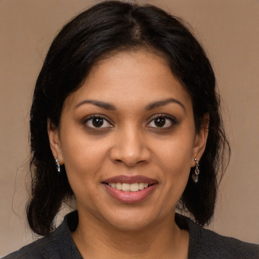 Joyful black young-adult female with medium  brown hair and brown eyes