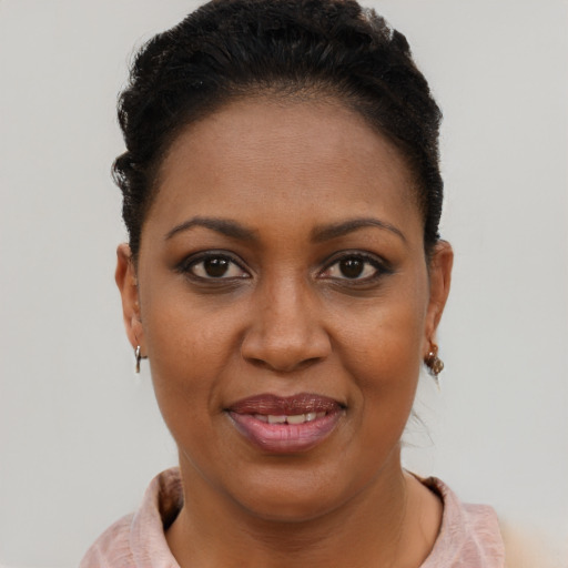 Joyful black young-adult female with short  brown hair and brown eyes