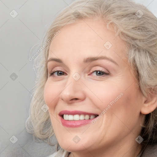 Joyful white adult female with medium  brown hair and blue eyes