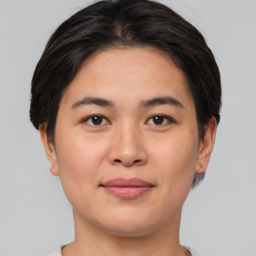 Joyful asian young-adult female with short  brown hair and brown eyes