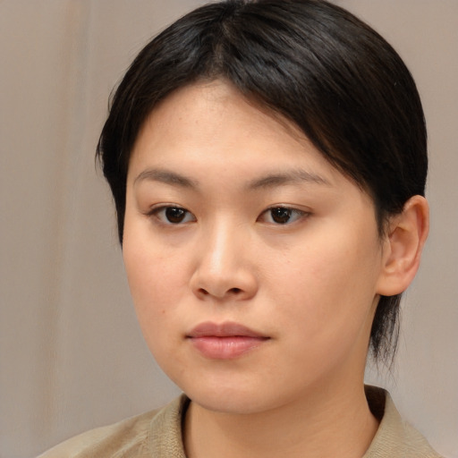 Neutral asian young-adult female with medium  brown hair and brown eyes