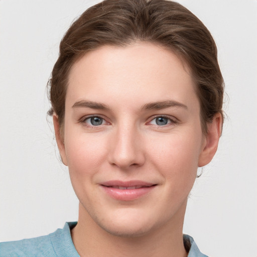 Joyful white young-adult female with medium  brown hair and blue eyes