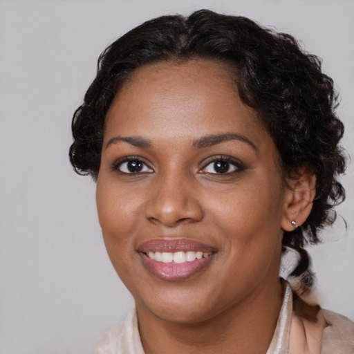 Joyful black young-adult female with medium  brown hair and brown eyes