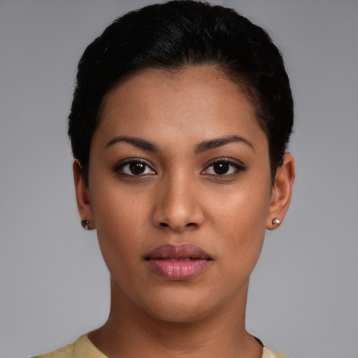 Joyful latino young-adult female with short  brown hair and brown eyes