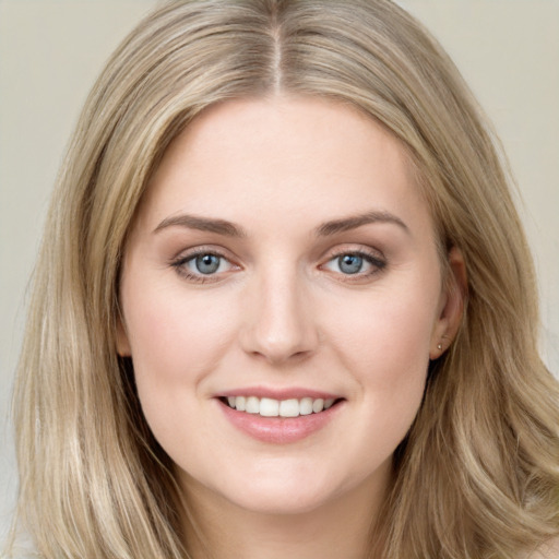 Joyful white young-adult female with long  brown hair and blue eyes