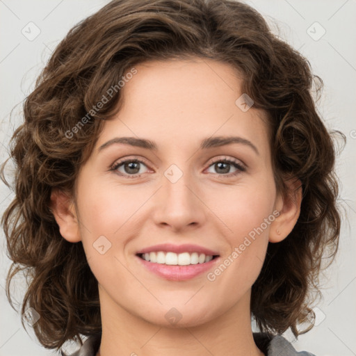 Joyful white young-adult female with medium  brown hair and green eyes