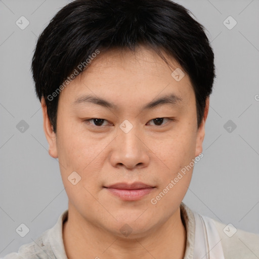 Joyful asian young-adult male with short  brown hair and brown eyes