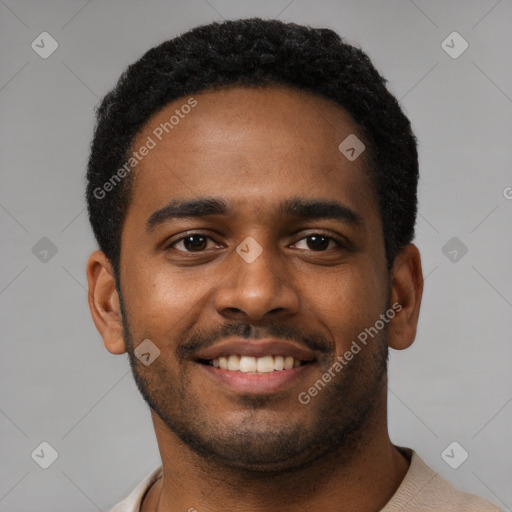 Joyful black young-adult male with short  black hair and brown eyes