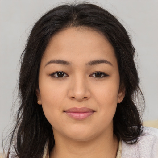 Joyful asian young-adult female with long  brown hair and brown eyes