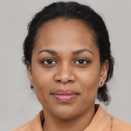 Joyful latino adult female with medium  brown hair and brown eyes