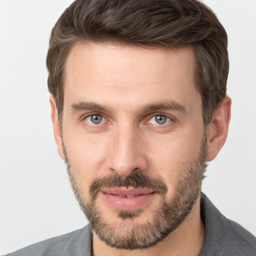 Joyful white adult male with short  brown hair and brown eyes