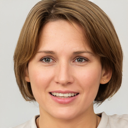 Joyful white adult female with medium  brown hair and grey eyes