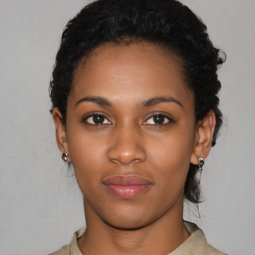 Joyful latino young-adult female with short  black hair and brown eyes