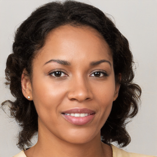 Joyful black young-adult female with medium  brown hair and brown eyes