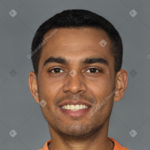 Joyful black young-adult male with short  black hair and brown eyes