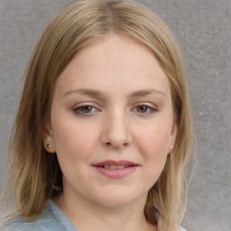 Joyful white young-adult female with medium  brown hair and blue eyes