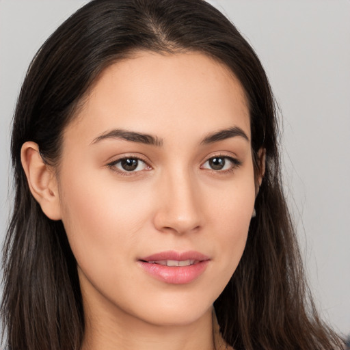 Joyful white young-adult female with long  brown hair and brown eyes