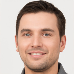 Joyful white young-adult male with short  brown hair and brown eyes