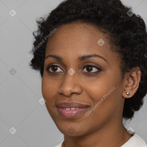 Joyful black young-adult female with short  black hair and brown eyes