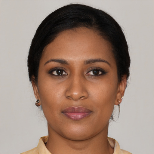Joyful black young-adult female with medium  brown hair and brown eyes