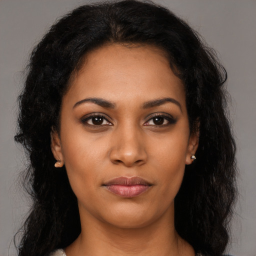 Joyful latino young-adult female with long  black hair and brown eyes