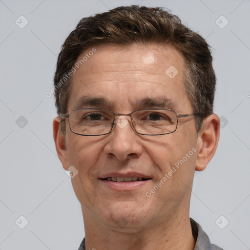 Joyful white middle-aged male with short  brown hair and brown eyes