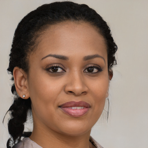Joyful black young-adult female with long  brown hair and brown eyes