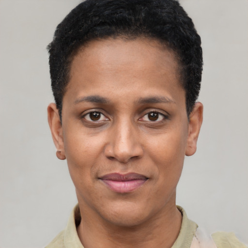 Joyful black young-adult female with short  black hair and brown eyes