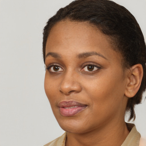 Joyful black young-adult female with medium  black hair and brown eyes