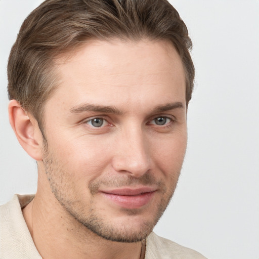 Joyful white young-adult male with short  brown hair and grey eyes