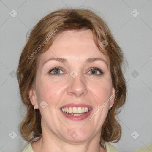 Joyful white adult female with medium  brown hair and blue eyes