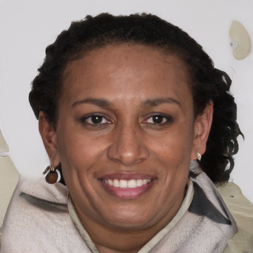 Joyful black adult female with short  brown hair and brown eyes