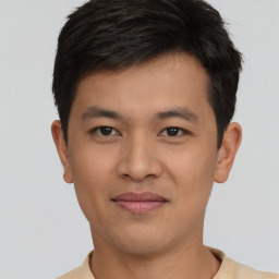 Joyful asian young-adult male with short  brown hair and brown eyes