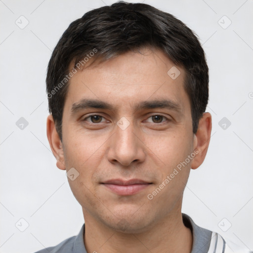 Joyful white young-adult male with short  black hair and brown eyes