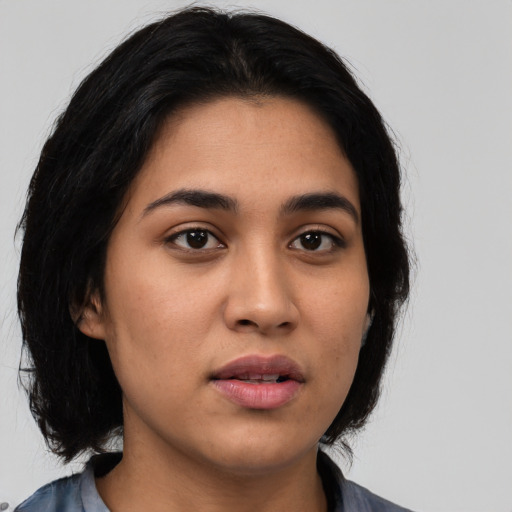 Neutral latino young-adult female with medium  black hair and brown eyes