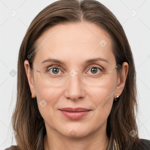 Joyful white adult female with long  brown hair and grey eyes