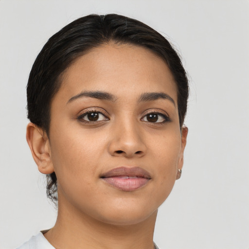 Joyful latino young-adult female with short  brown hair and brown eyes