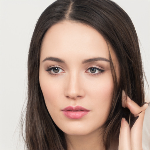 Neutral white young-adult female with long  brown hair and brown eyes