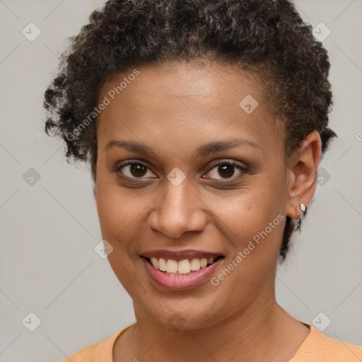 Joyful black young-adult female with short  brown hair and brown eyes