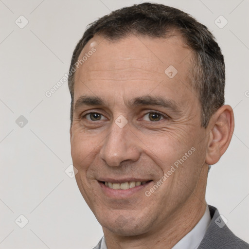 Joyful white adult male with short  brown hair and brown eyes