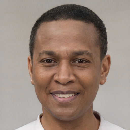 Joyful latino adult male with short  black hair and brown eyes