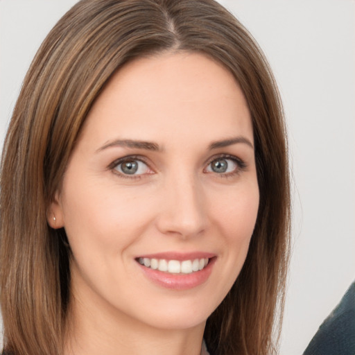 Joyful white young-adult female with long  brown hair and brown eyes