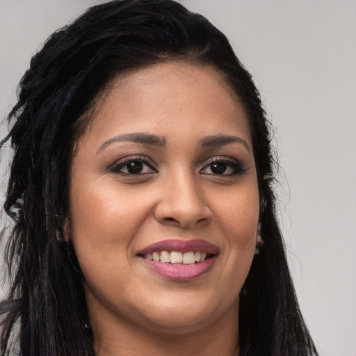 Joyful latino young-adult female with long  brown hair and brown eyes