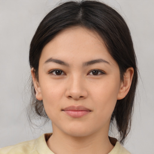 Joyful latino young-adult female with medium  brown hair and brown eyes