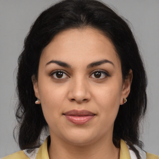 Joyful latino young-adult female with medium  brown hair and brown eyes