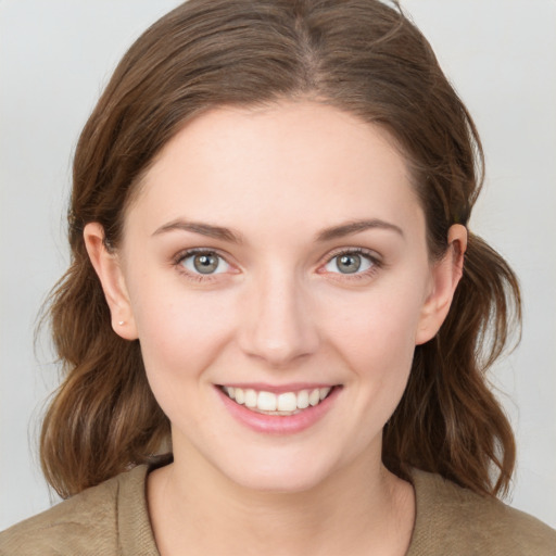 Joyful white young-adult female with medium  brown hair and blue eyes