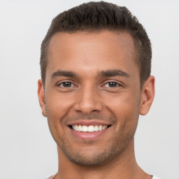 Joyful white young-adult male with short  brown hair and brown eyes