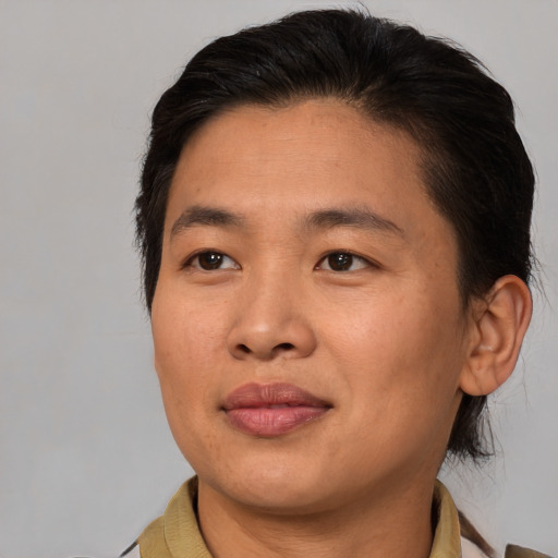 Joyful asian adult male with medium  brown hair and brown eyes