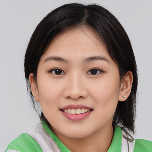 Joyful white young-adult female with medium  brown hair and brown eyes